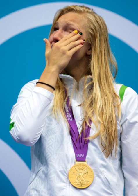 An emotional Ruta Meilutyte with her gold medal on the podium